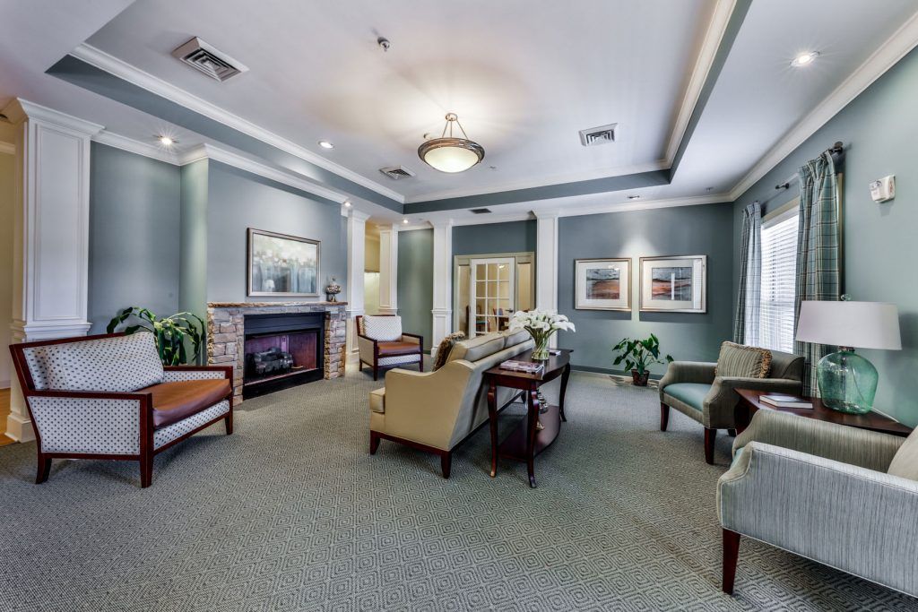 A well-appointed living room with a fireplace, comfortable seating, and tasteful decor.