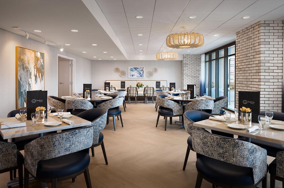 A modern and elegant restaurant interior with stylish seating arrangements and large windows.