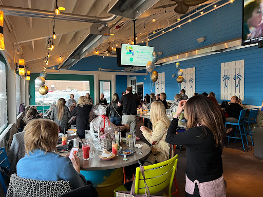 A lively gathering at a restaurant, filled with people celebrating together.