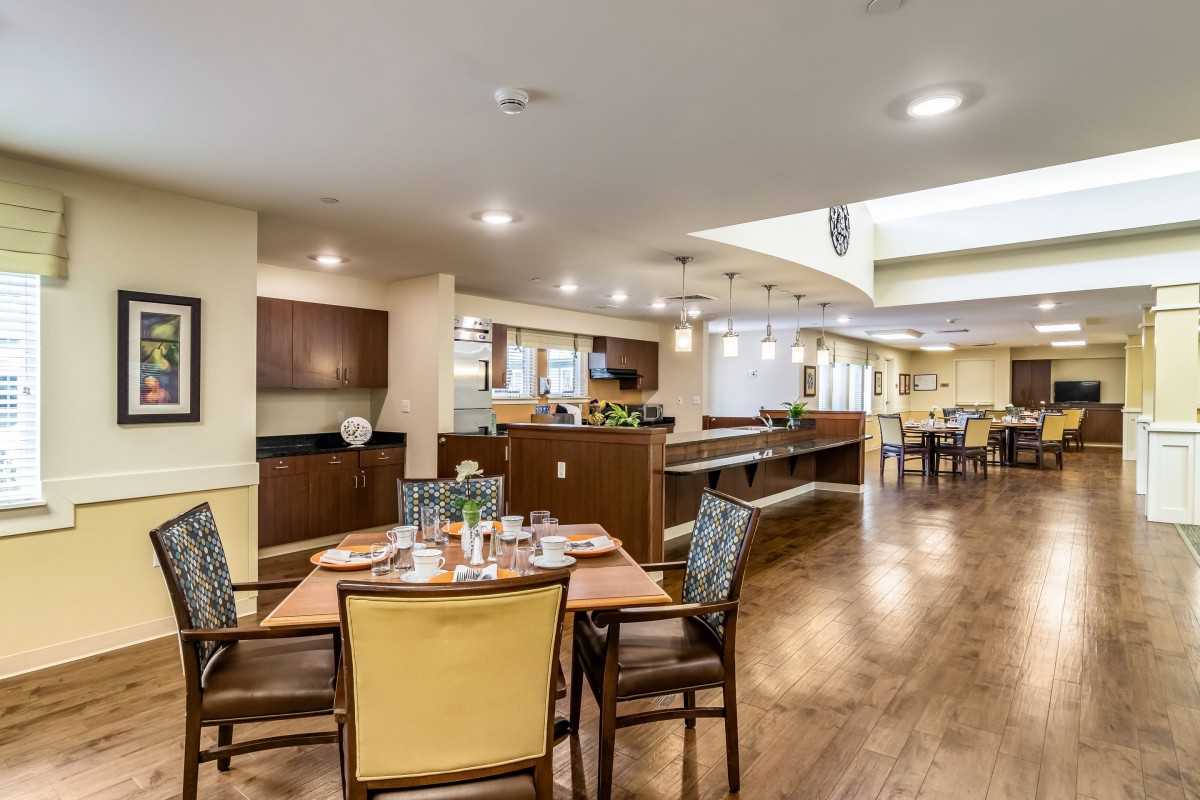 A modern dining area with stylish furniture and warm lighting.