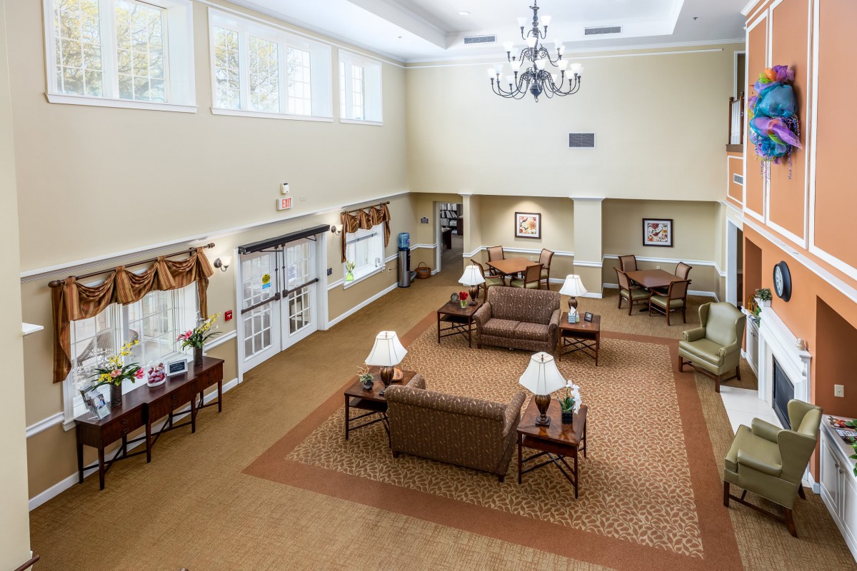 A spacious lobby area with comfortable seating and a large chandelier.