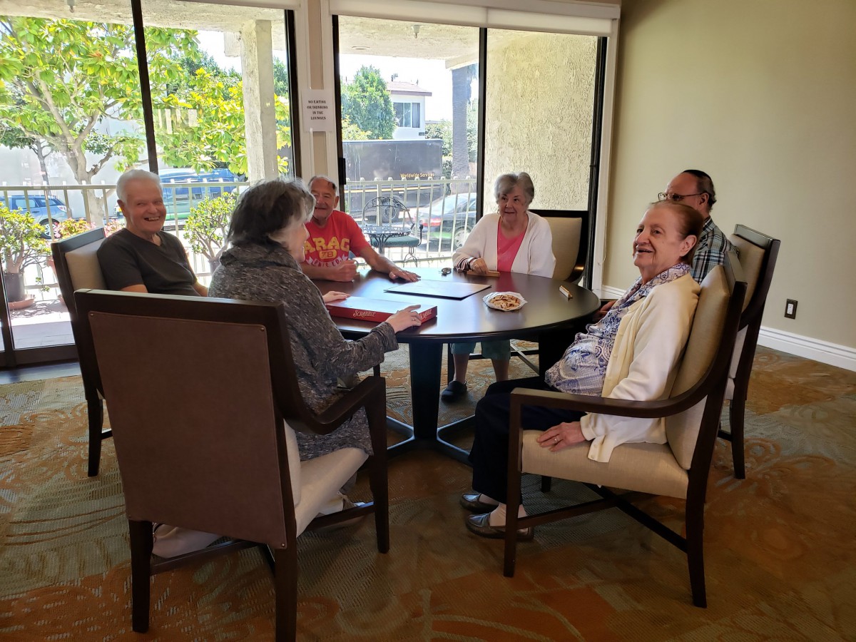 A group of seniors gathered around a table for a meeting.