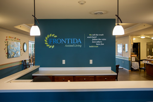 The welcoming reception area of Frontida Assisted Living, showcasing modern design and a calming blue color scheme.