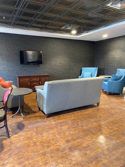 A modern living room with comfortable seating and a mounted television.