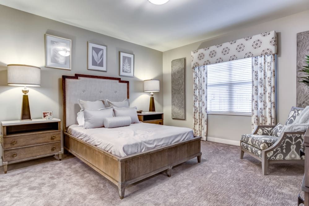 A modern bedroom with elegant furnishings and tasteful decor.