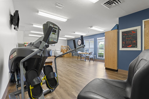 A view of a fitness area featuring exercise equipment, designed for rehabilitation and wellness.