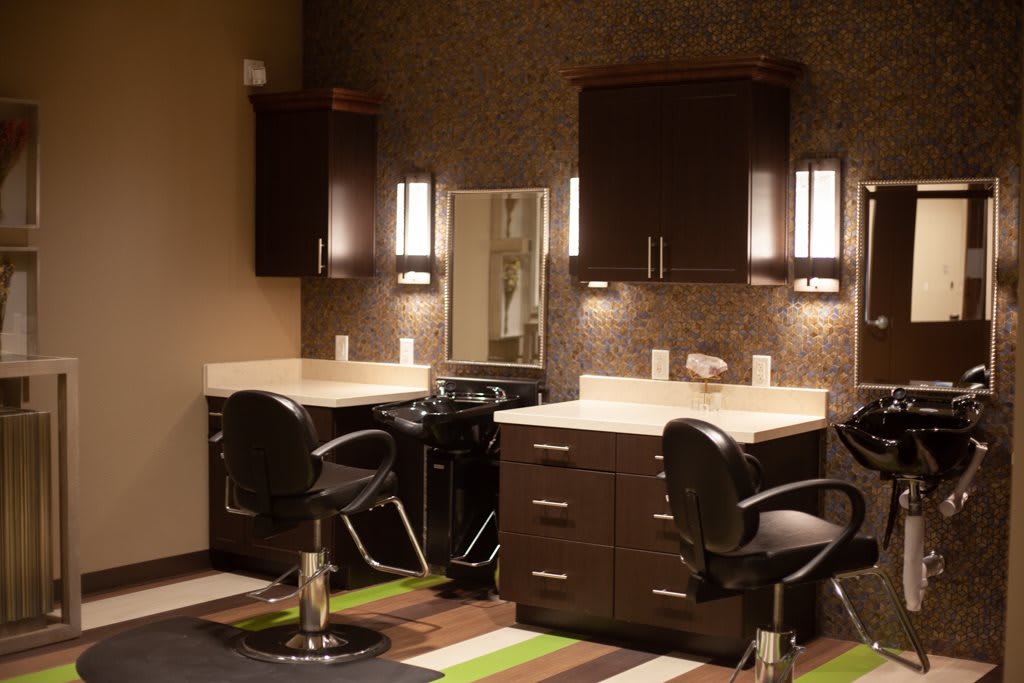 Elegant and modern hair salon interior with styling stations and comfortable chairs.