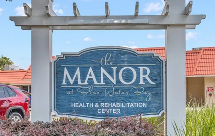 A sign for The Manor Health & Rehabilitation Center.