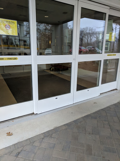 The entrance of a shopping center featuring automated glass doors.