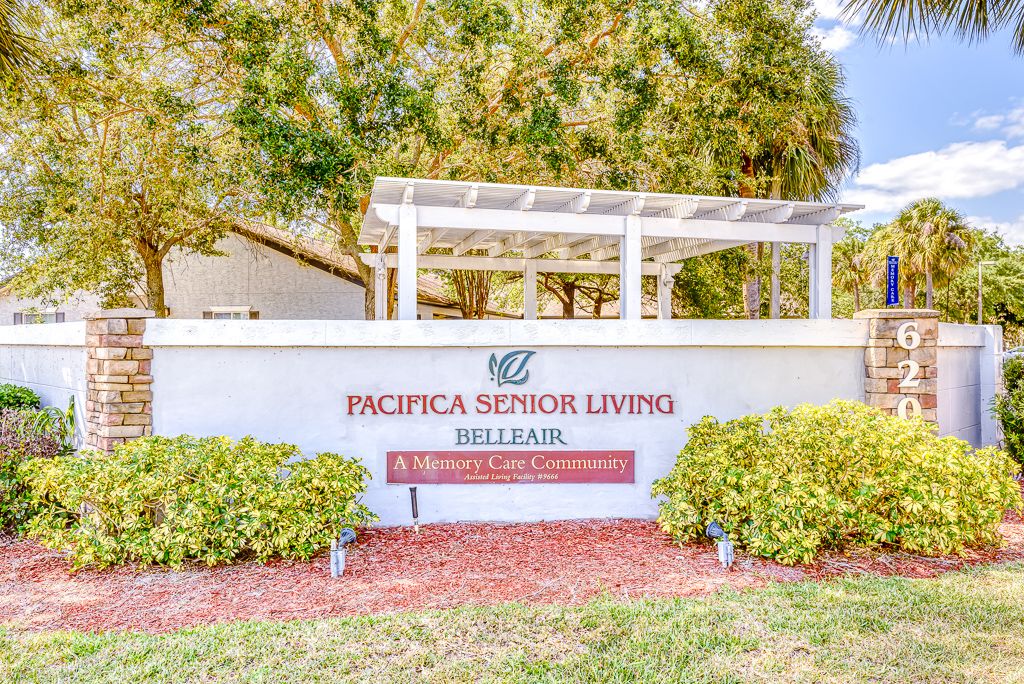 Pacifica Senior Living Belleair entrance sign surrounded by greenery.