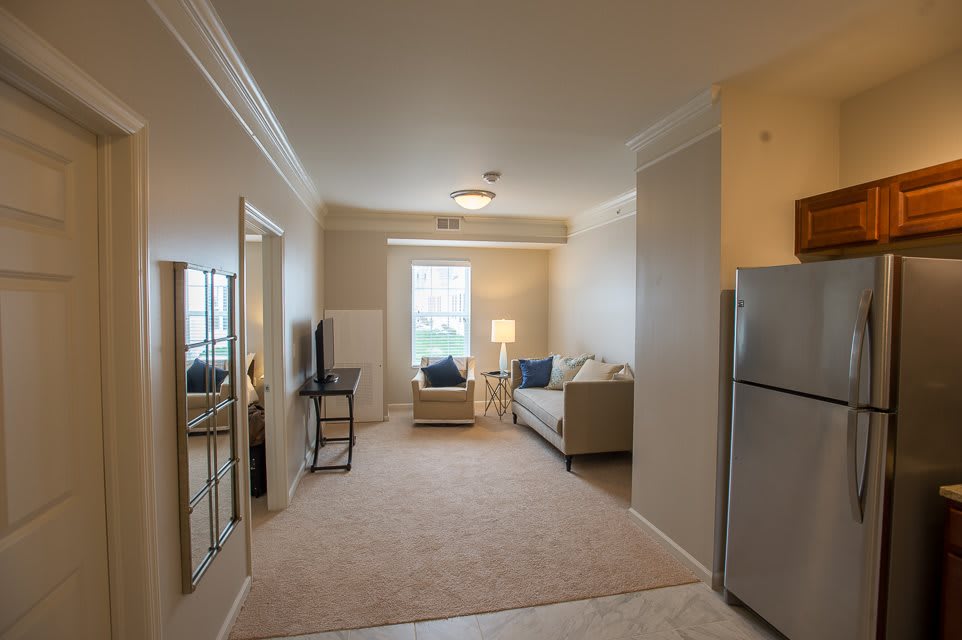 A cozy living room interior in an apartment with a sofa, television, and window.
