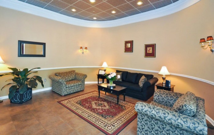 A cozy living room with comfortable seating and warm lighting.