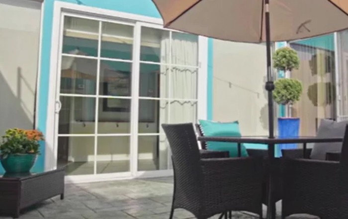 Outdoor patio seating area with an umbrella and modern furniture.