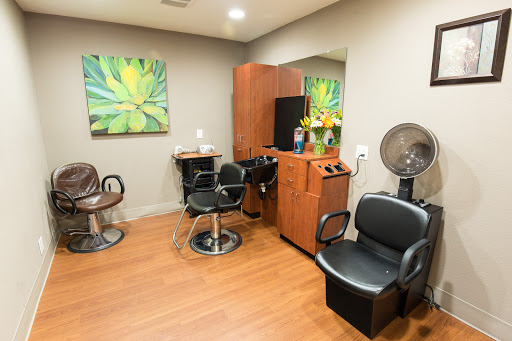 A well-designed salon space featuring comfortable chairs, stylish decor, and ample lighting for hair styling services.