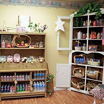 A cozy shop interior displaying various products on wooden shelves.