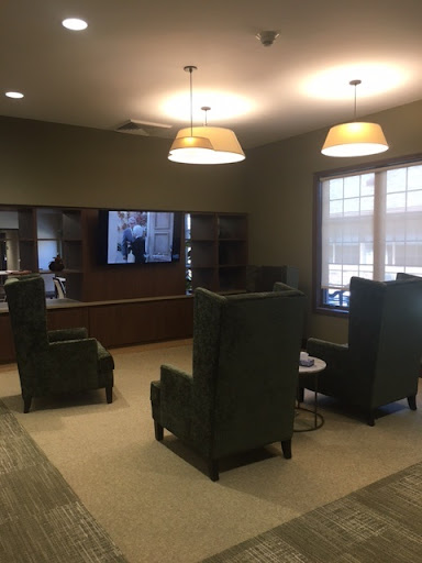 A cozy indoor lounge featuring comfortable seating and a TV for entertainment.