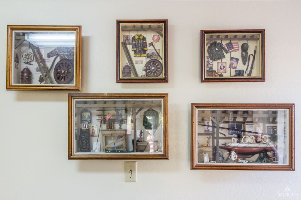 A collection of framed pictures displayed on a wall.