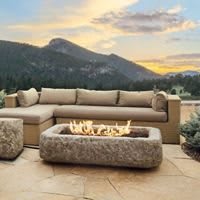 Cozy outdoor patio with a fire pit and mountain views at sunset.
