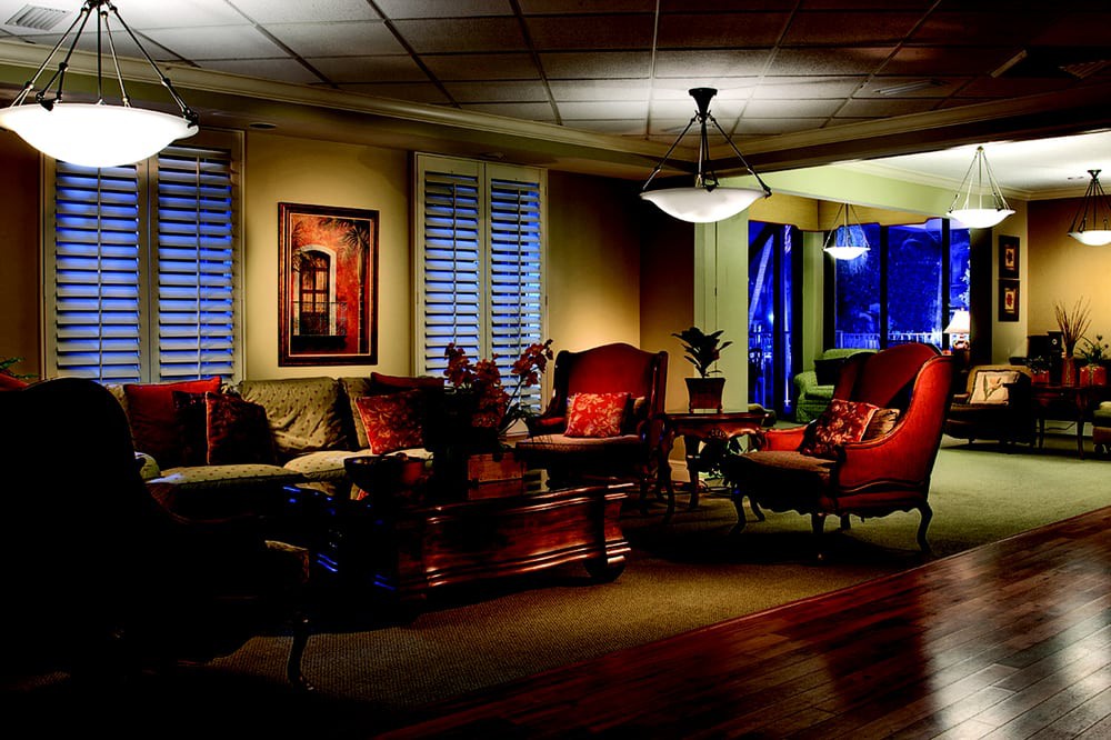 A cozy and warmly lit living room featuring comfortable seating and elegant decor.