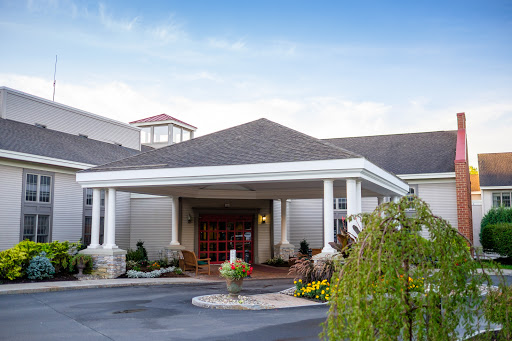 The welcoming entrance of a hotel, featuring well-maintained landscaping and elegant architecture.