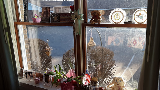 A cozy window scene featuring decorations, plants, and a touch of sunlight.