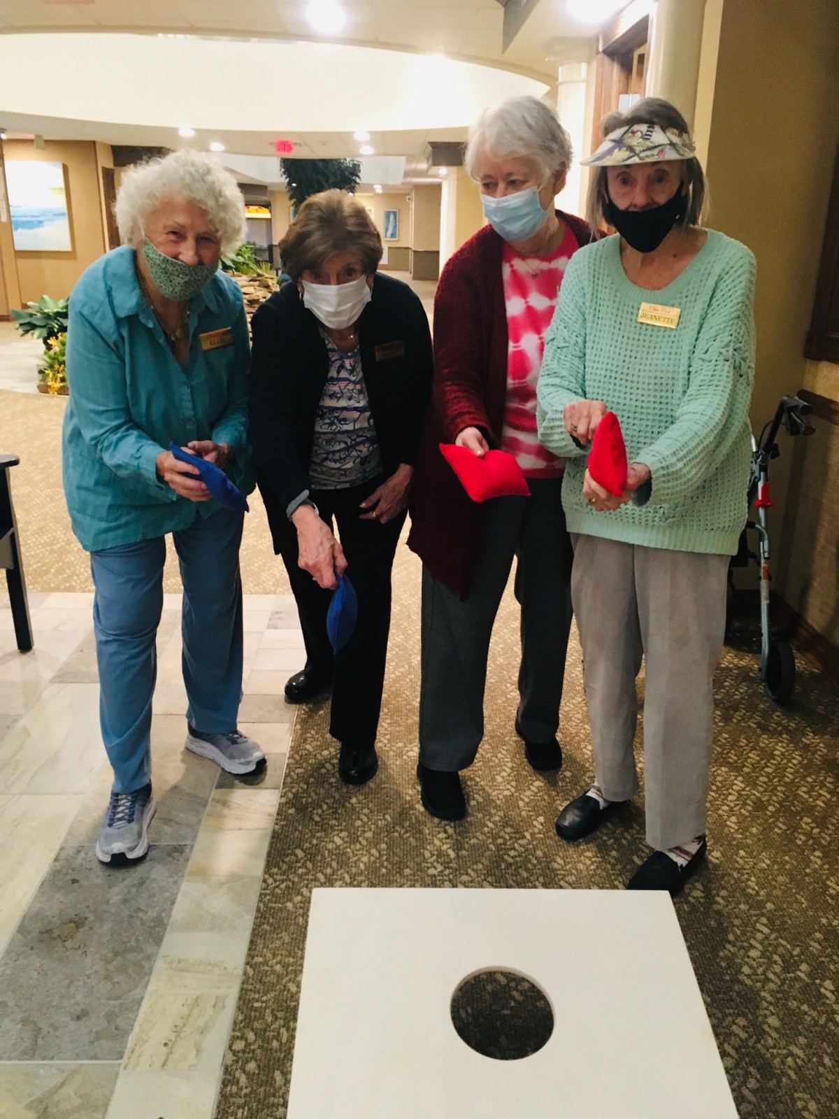 A group of seniors enjoying a game indoors.