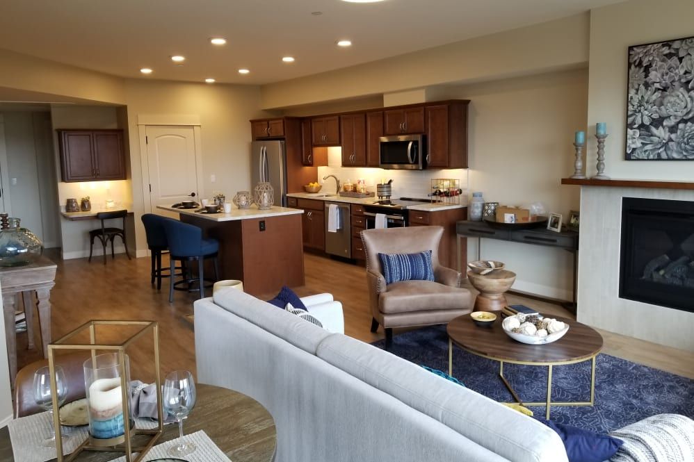 A modern open floor plan living room and kitchen with stylish furnishings and decor.