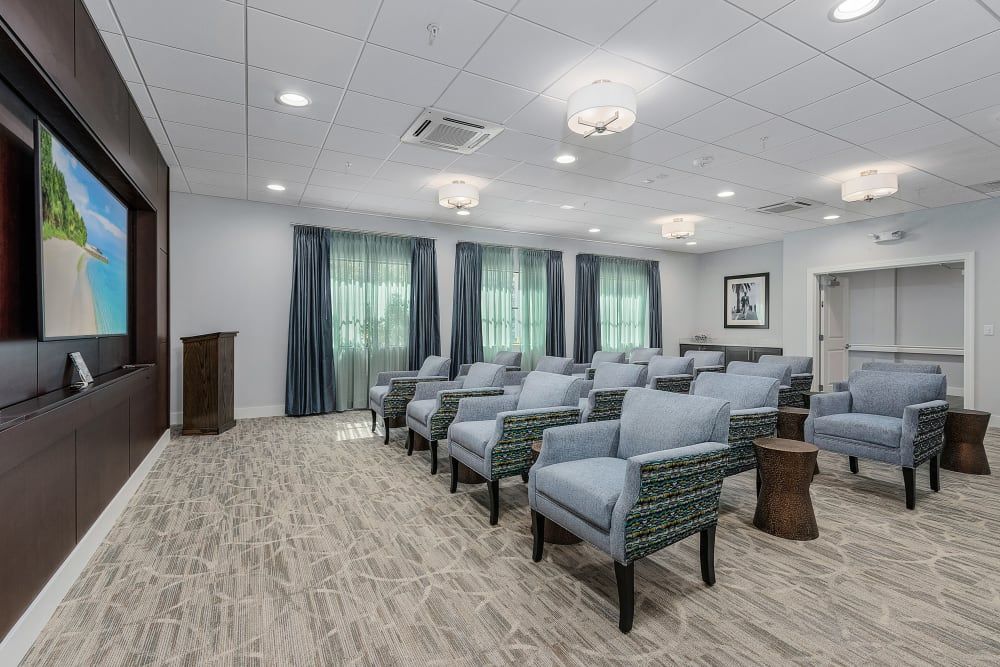 A modern conference room with neatly arranged seating and a podium at the front.
