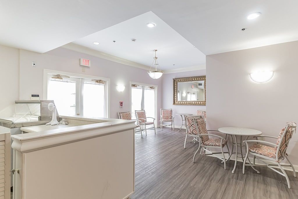 A modern and bright waiting room with comfortable seating and a reception desk.