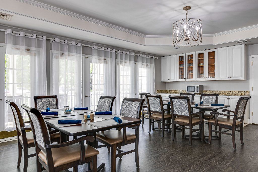 A beautifully designed dining room with elegant furniture and a modern chandelier.