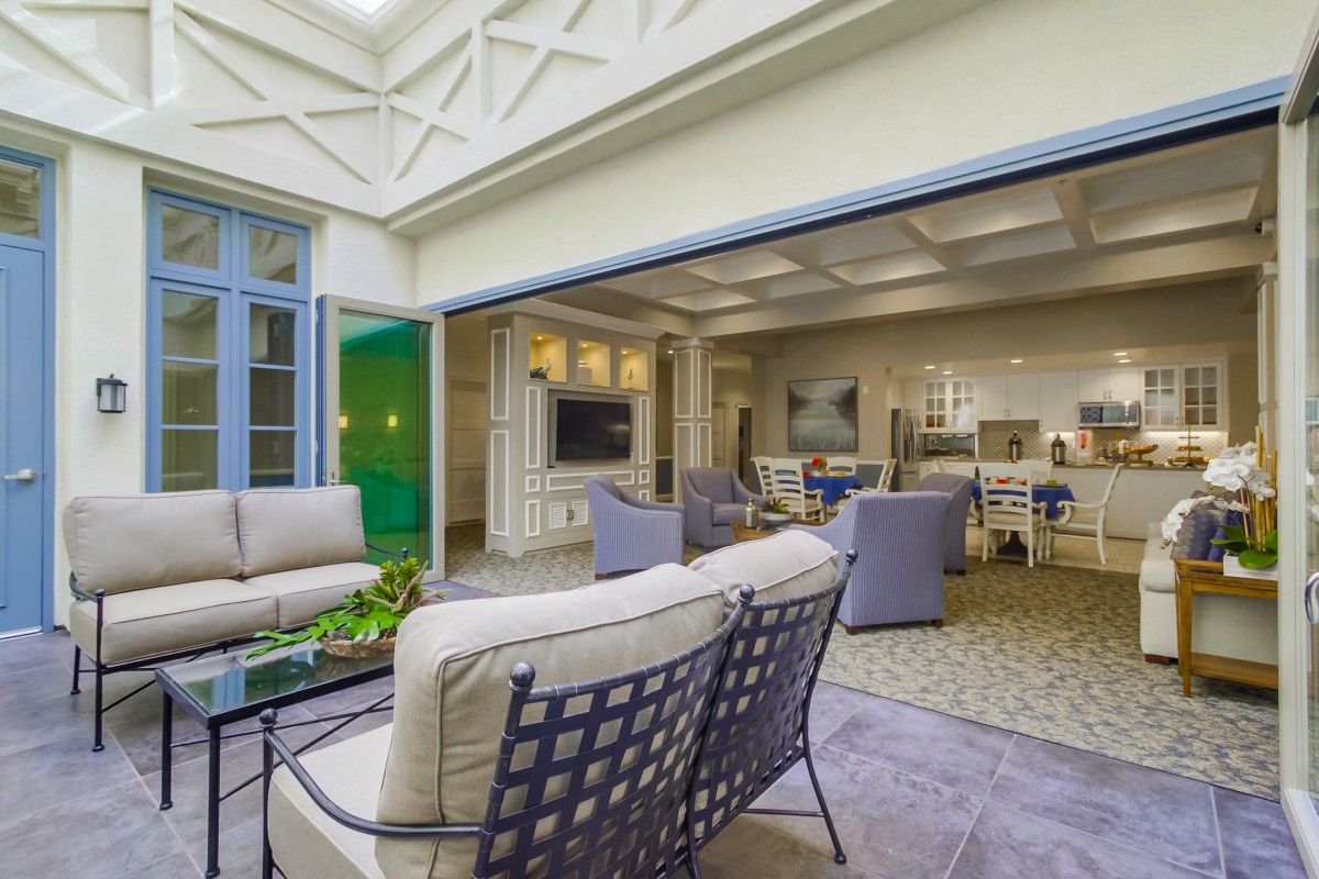 A spacious indoor-outdoor living area with comfortable seating and abundant natural light.