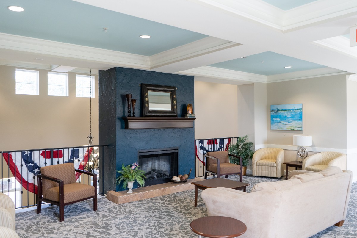 A modern living room featuring a stylish fireplace, comfortable seating, and decorative elements.