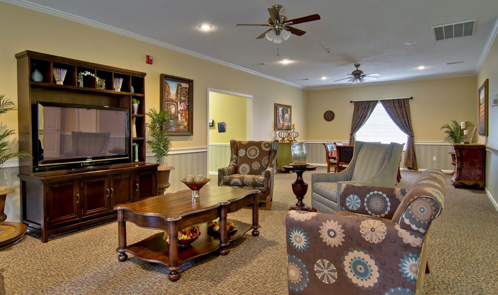 A cozy living room featuring comfortable seating, a television, and elegant decor.