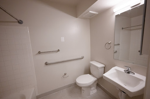 A modern bathroom designed with accessibility features including grab bars for safety.