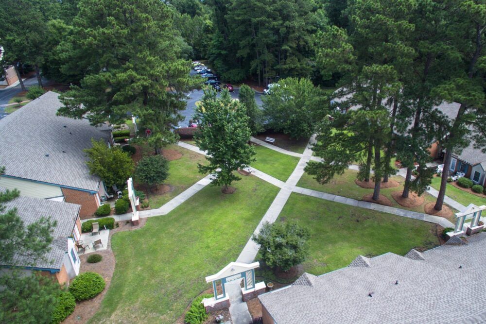 Aerial view of a landscaped area with pathways and surrounding greenery.