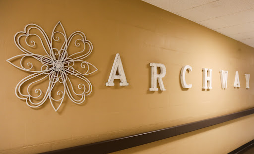A beautifully designed wall featuring the word 'ARC' and decorative elements.