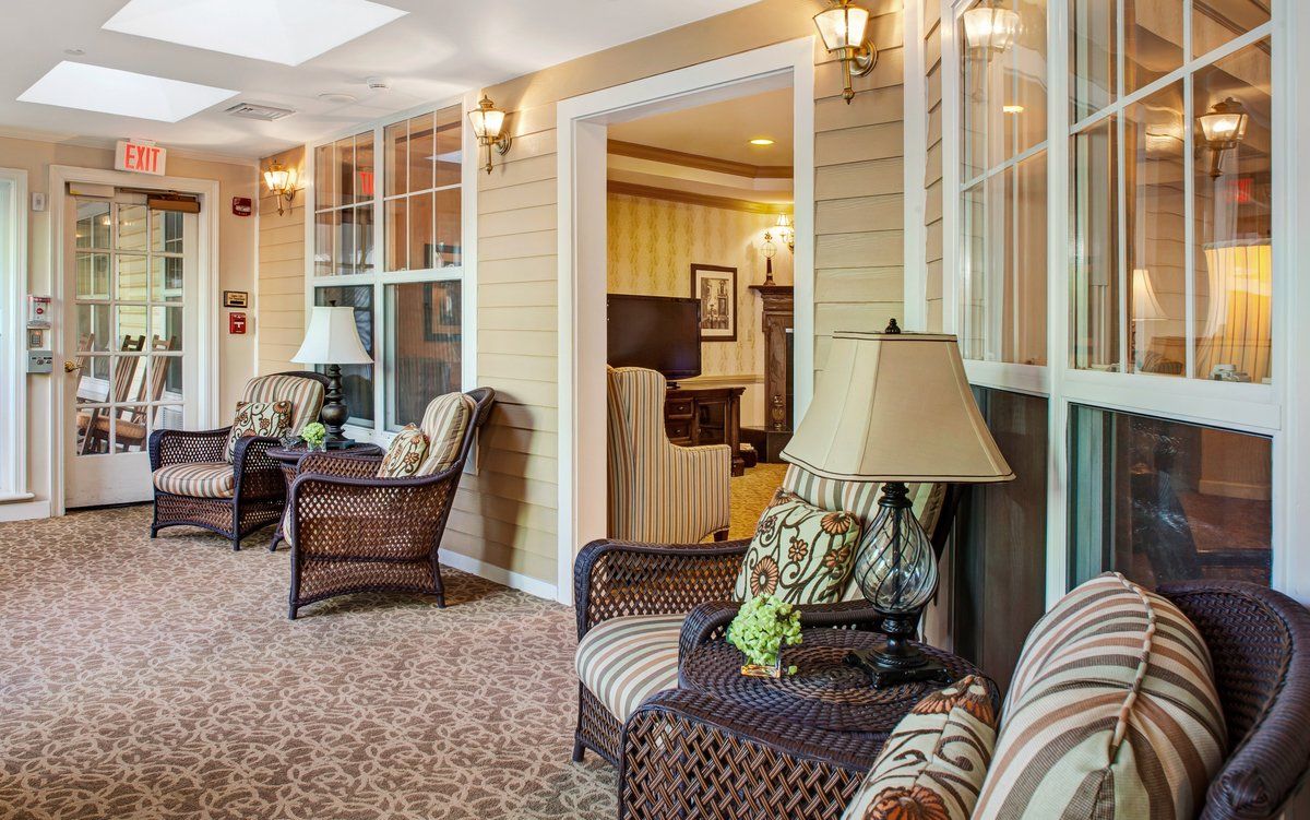 A cozy living room with armchairs, decorative lamps, and a patterned carpet.