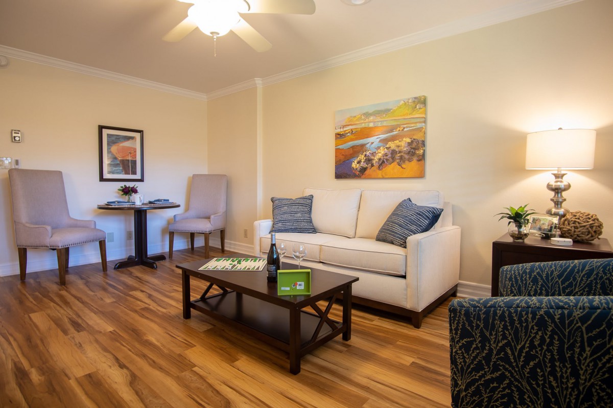 A cozy living room with a comfortable sofa, stylish coffee table, and vibrant artwork on the wall.