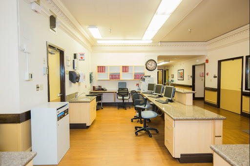 A clean and organized medical office space featuring workstations and a waiting area.