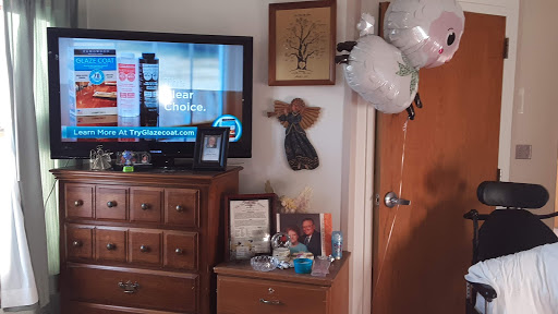 A cozy living room setup featuring a television, decorative items, and balloons.