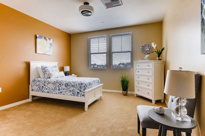A cozy bedroom with a bed, dresser, and stylish decor.