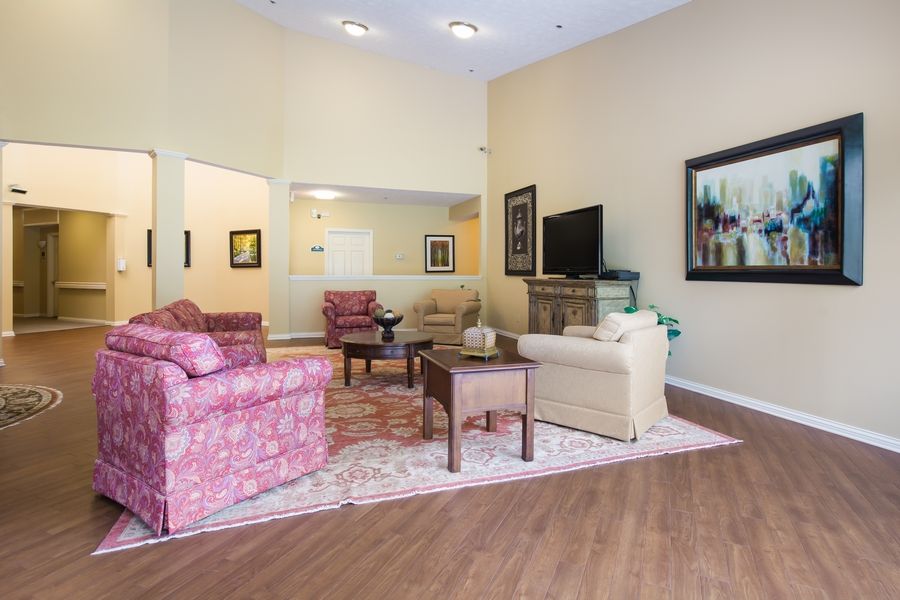 A cozy living room with comfortable furniture and a television.
