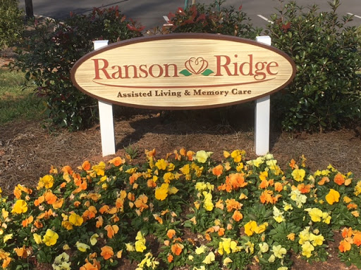 The entrance sign for Ranson Ridge, featuring a beautiful flower bed.