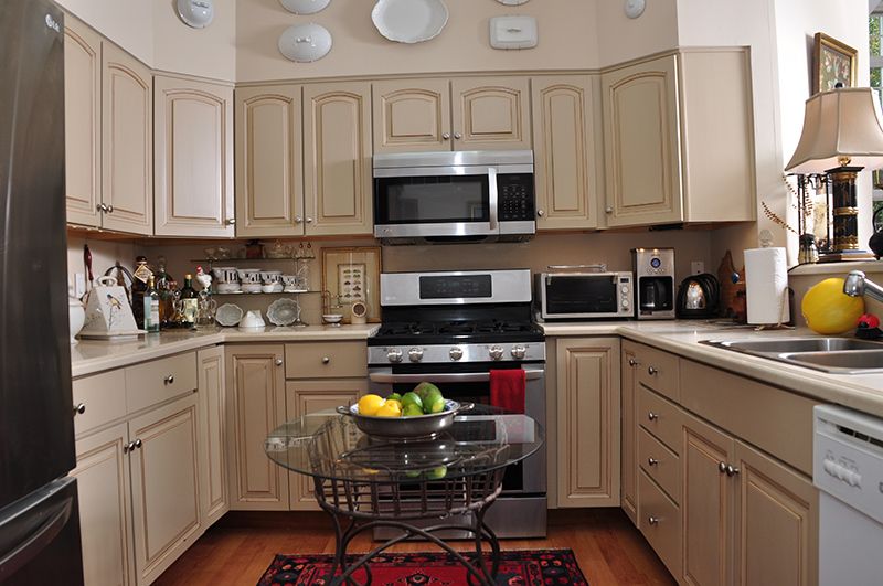 A cozy kitchen with modern appliances and a fruit bowl on the table.