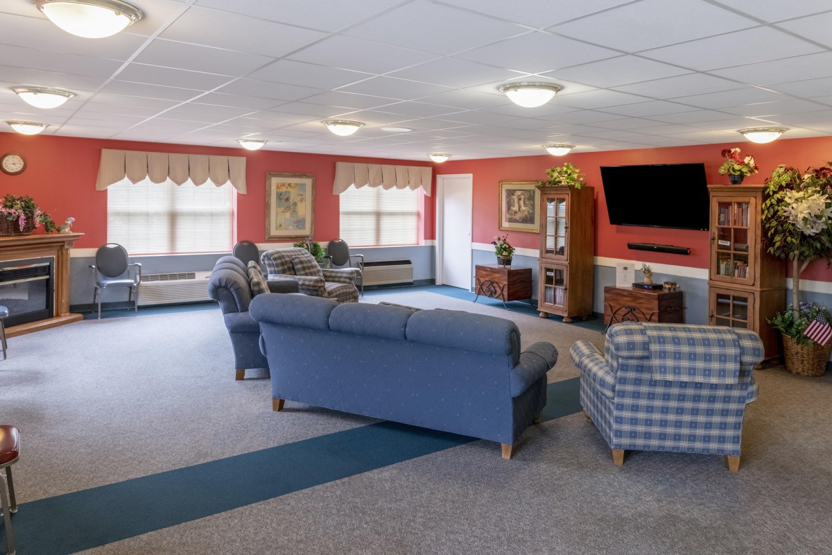A spacious living room with comfortable seating and a large television.