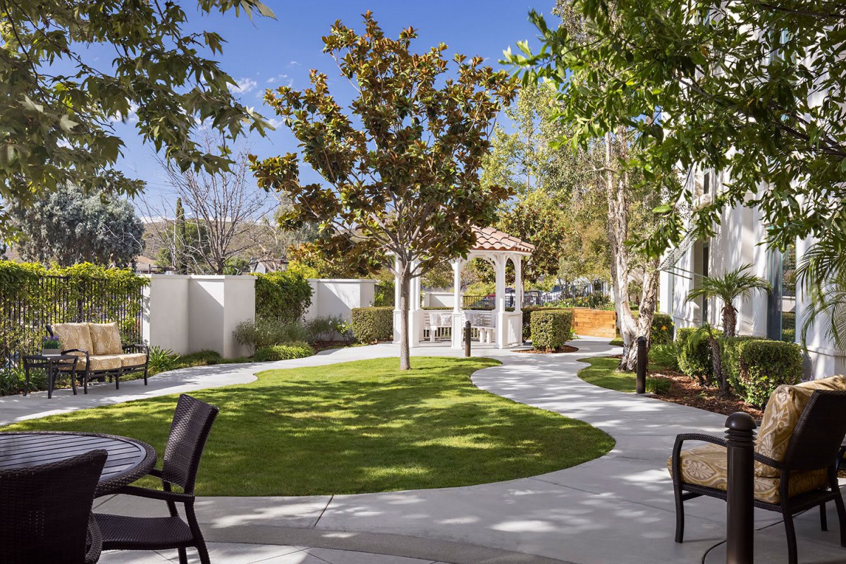 A beautifully landscaped garden with a gazebo and winding pathway.