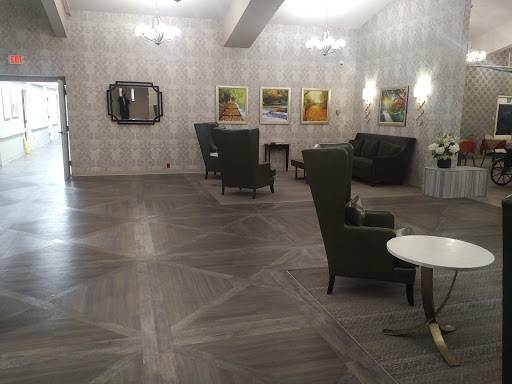 A spacious and modern lobby featuring comfortable seating and artwork on the walls.