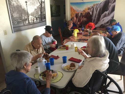 A group of seniors enjoying a meal together in a communal dining area.