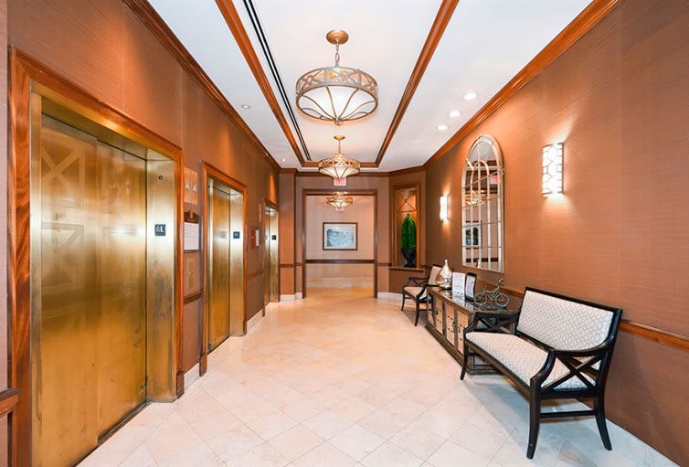 A stylish elevator lobby with warm lighting and elegant interior design features.