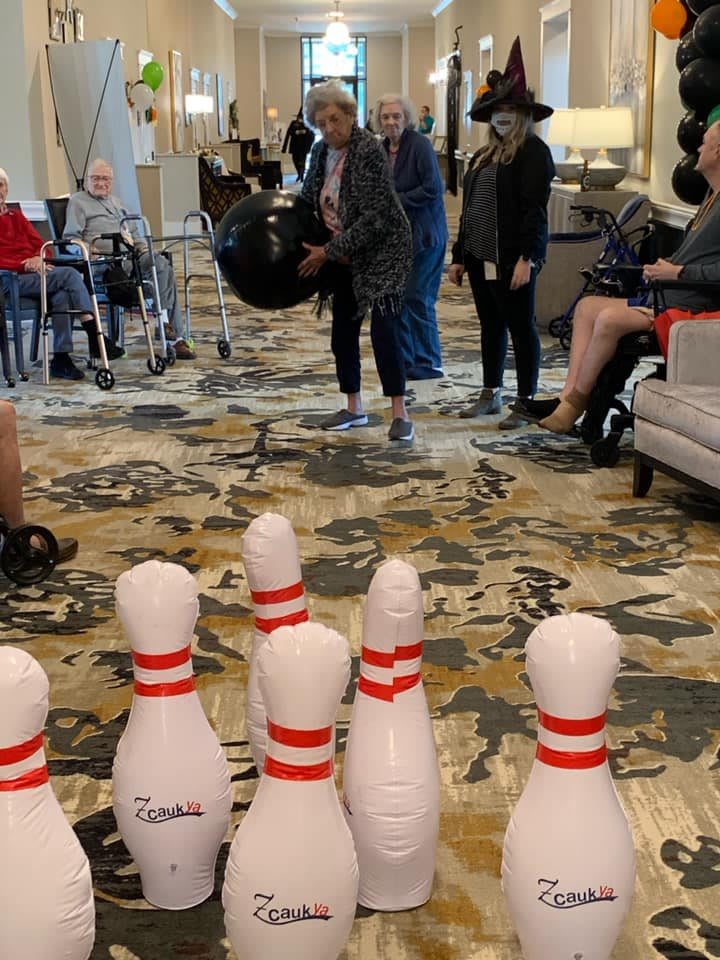 Seniors enjoying a fun indoor bowling activity.